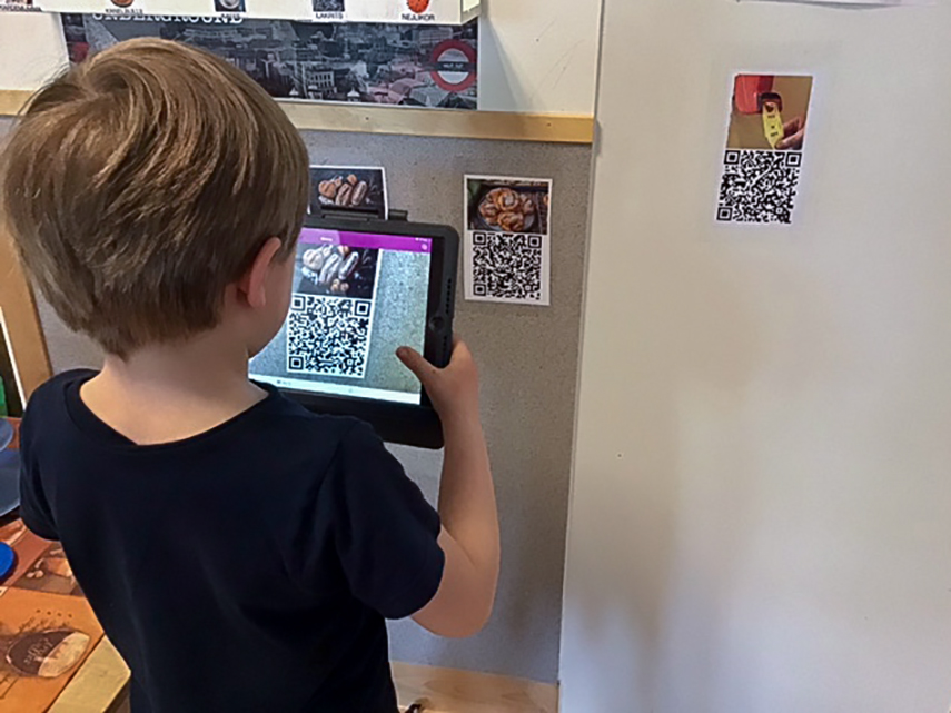 Pojke betalar med iPad via QR-kod på förskolan