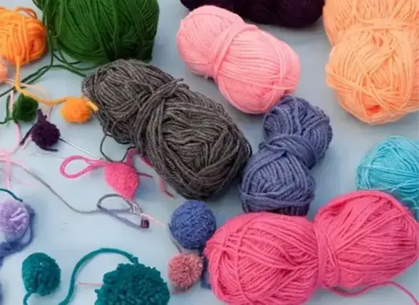 Garnnystan i olika färger på ett bord.